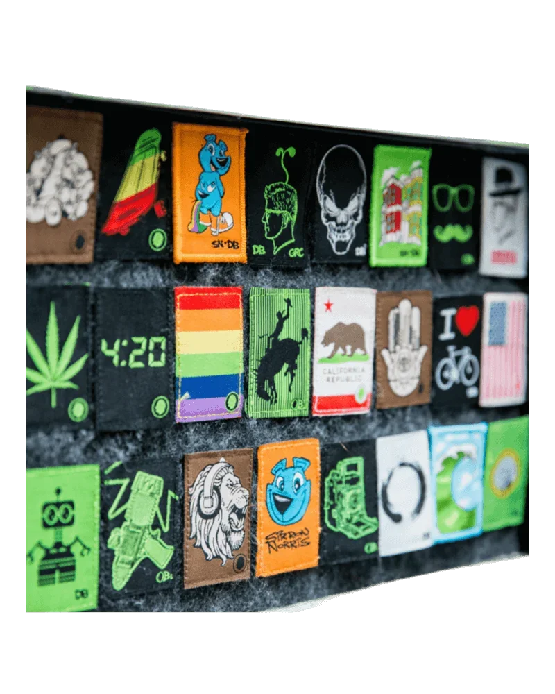 Dime Bags Velcro Patch collection display featuring colorful cannabis-themed patches including leaf, skull, rainbow, bear, and graphic designs on black backing