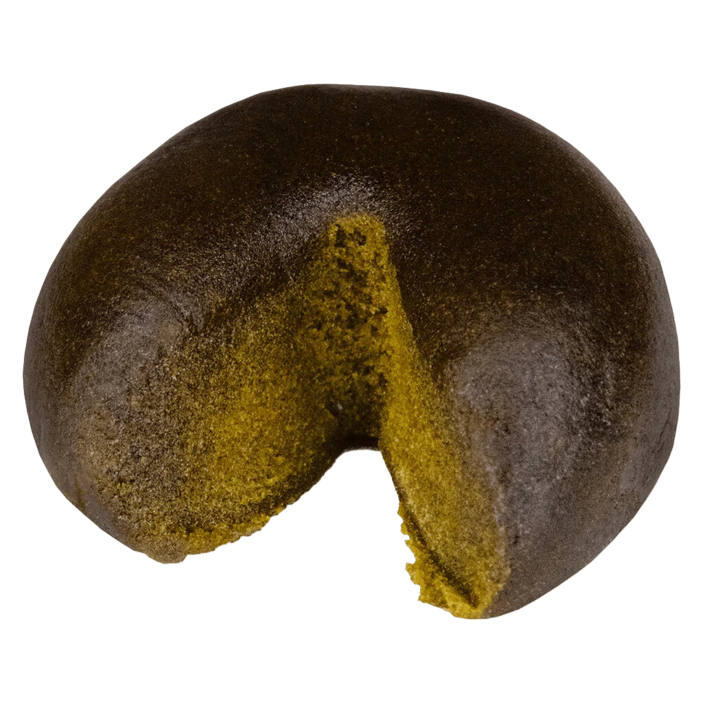 XK Haschtag STRWBRRY cannabis hash with yellow-green kief coating and dark interior visible in cross-section