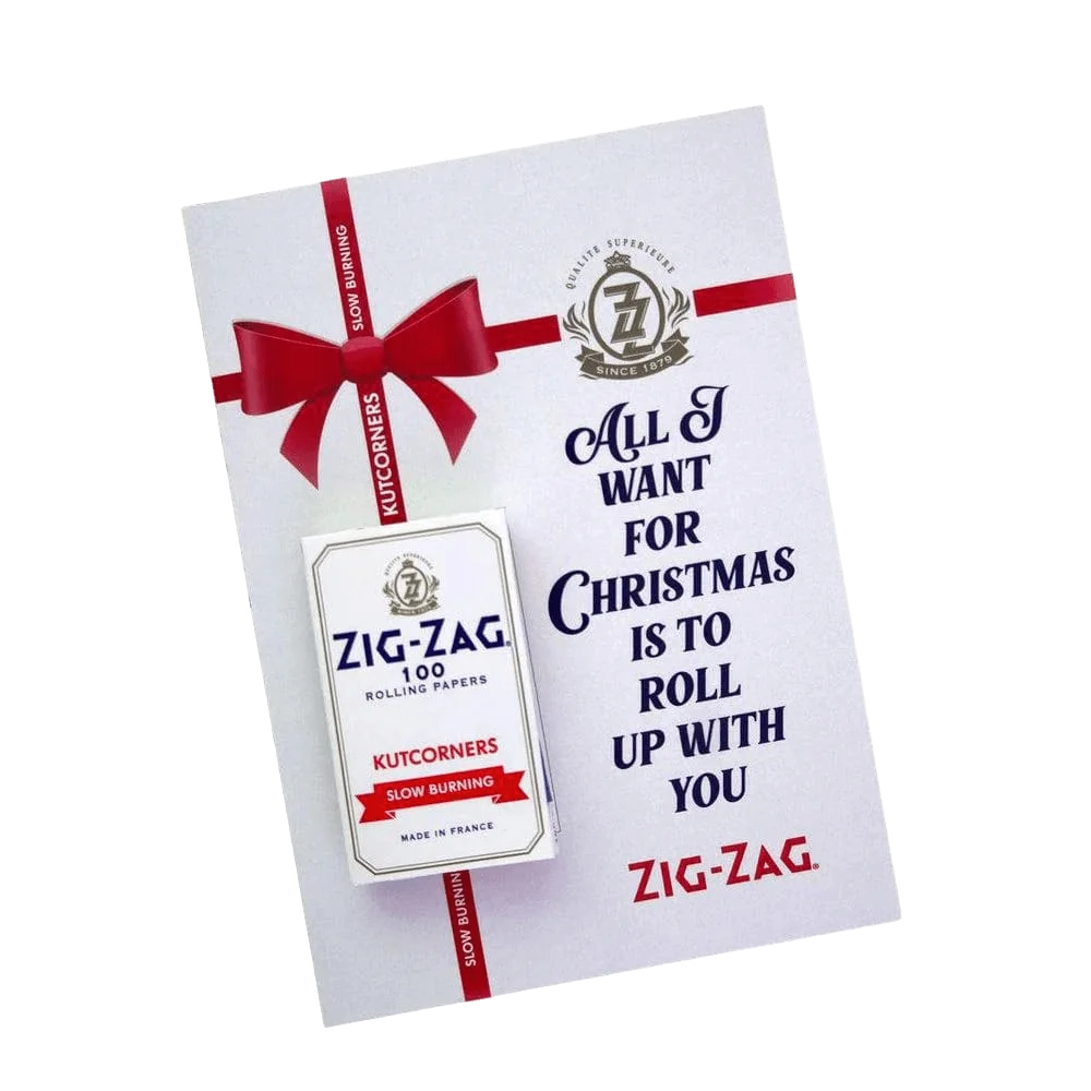 Zig-Zag 100 rolling papers kutcorners package with red ribbon bow and Christmas-themed promotional card